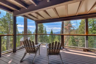 two chairs on a porch with a view of the mountains at Tahoe Point of View - Amazing Lake Views at this 4BR w Hot Tub, Sauna, Near Skiing in Tahoe City