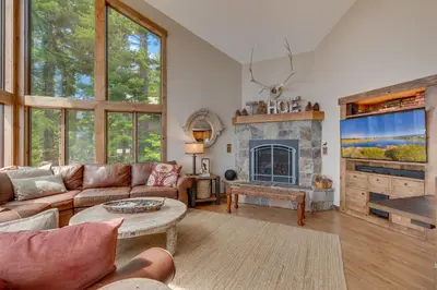 a living room with a couch and a fireplace at Tahoe Point of View - Amazing Lake Views at this 4BR w Hot Tub, Sauna, Near Skiing in Tahoe City