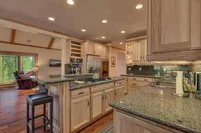 a large kitchen with wooden cabinets and granite counter tops at Starlight Retreat at Gray's Crossing in Truckee