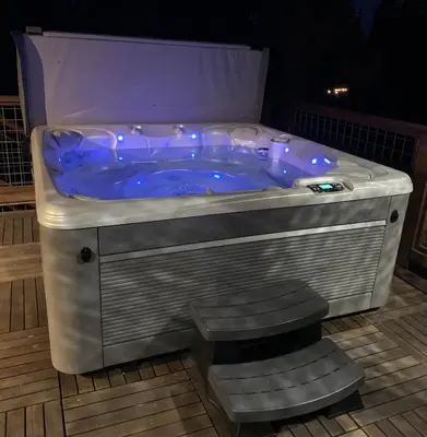 a jacuzzi tub with stairs in a room at Tahoe Rim Retreat - Spacious 4BR with Pool Table and Private Hot Tub - Pet Friendly! in Kings Beach