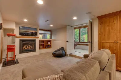 a living room with a couch and a fireplace at Tahoe Rim Retreat - Spacious 4BR with Pool Table and Private Hot Tub - Pet Friendly! in Kings Beach