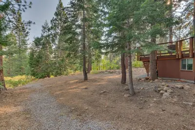 a road leading to a house with trees in front at Tahoe Rim Retreat - Spacious 4BR with Pool Table and Private Hot Tub - Pet Friendly! in Kings Beach
