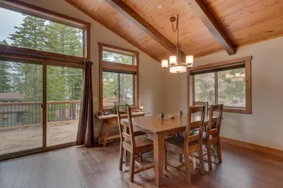 a dining room with a table and chairs and windows at Skyland Jewel at Dollar Point - Luxury 3BR - Easy Winter Access in Tahoe City