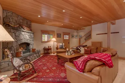 a large living room with a stone fireplace at Tahoe Time on North Shore - 4 BR Cabin w Private Hot Tub, Pet Friendly, Walk to Dining in Tahoe Vista