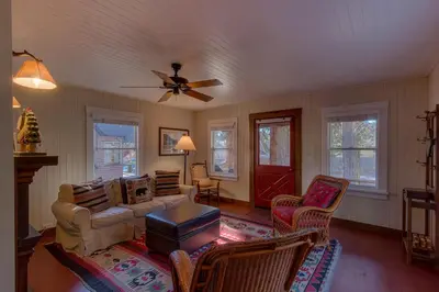 a living room with a ceiling fan and chairs at Vanni House - Classic Tahoe Style 2 BR - Sleeps 6 - Hot Tub - Near Palisades & Downtown Tahoe City in Tahoe City