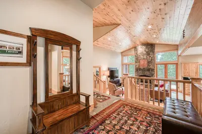 a living room with a large mirror on the wall at Truckee Timbers at Gray's Crossing by Tahoe Getaways - 4BR w Hot Tub, Ping Pong & EV in Truckee