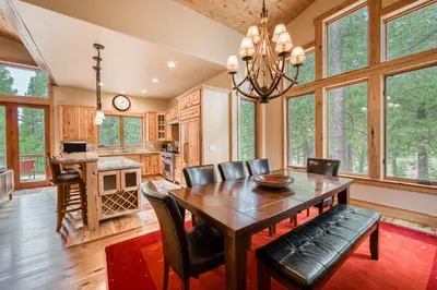 a dining room with a table and chairs at Truckee Timbers at Gray's Crossing by Tahoe Getaways - 4BR w Hot Tub, Ping Pong & EV in Truckee