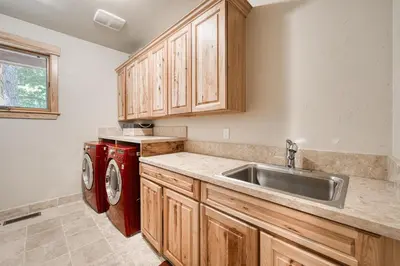 a kitchen with a sink and a washing machine at Truckee Timbers at Gray's Crossing by Tahoe Getaways - 4BR w Hot Tub, Ping Pong & EV in Truckee