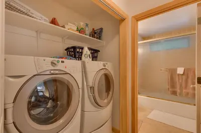 a washer and dryer in a small laundry room at Tahoma Charm on West Shore - Beautiful Open Concept 3 BR w Private Hot Tub in Tahoma
