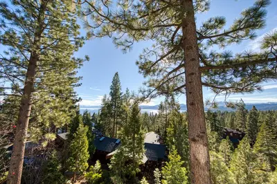 a cabin in the woods with trees at View at Dollar Point - Beautiful Lake Views with Sunny Deck, Quiet Neighborhood, Near Skiing in Tahoe City