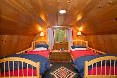 a bedroom with two beds in a wooden house at Ward Creek Retreat - Cozy Old Tahoe Cabin w Short Drive to Ski Resorts Pet Friendly in Tahoe City