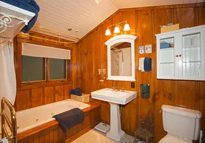 a bathroom with a tub and a sink and a toilet at Ward Creek Retreat - Cozy Old Tahoe Cabin w Short Drive to Ski Resorts Pet Friendly in Tahoe City