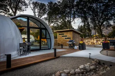 a dome house with a patio and a table at Sequoia Studio Suites in Three Rivers