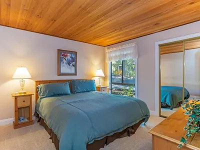 a bedroom with a large bed with a wooden ceiling at 223 Forest Pines short walk to bike path and the Hyatt Casino in Incline Village