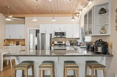 a kitchen with a large island with bar stools at The perfect Forest Pines getaway in Incline Village