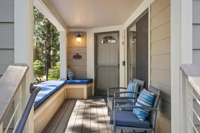 a porch with two chairs and a door at The perfect Forest Pines getaway in Incline Village