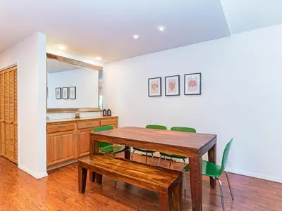 a dining room with a wooden table and green chairs at 252 McCloud Upper level unit in Incline Village
