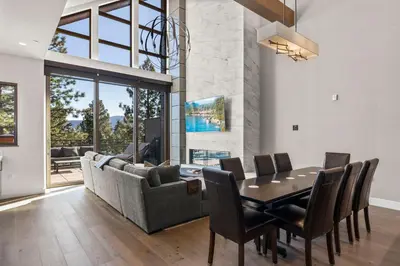 a dining room with a table and a couch at Appreciate this exclusive private penthouse located on Lake Tahoe in Crystal Bay