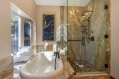 a large bathroom with a tub and a shower at Fabulous Views Of Lake Tahoe in Crystal Bay