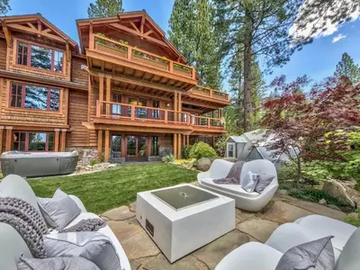 a log home with a patio with white furniture at A Touch Of Tuscany In a Lake Tahoe Estate in Incline Village
