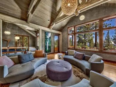 a living room with couches and a table and windows at A Touch Of Tuscany In a Lake Tahoe Estate in Incline Village