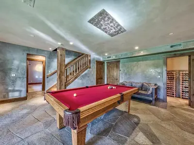 a pool table in a room with a staircase at A Touch Of Tuscany In a Lake Tahoe Estate in Incline Village