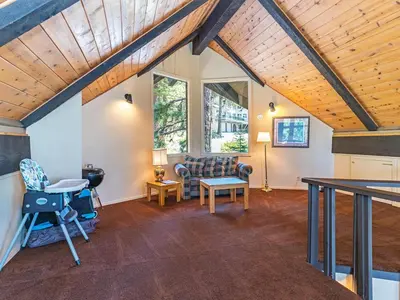 a living room with a couch and a table at Enjoy the brilliant views of Lake Tahoe from this mountainside Cabin in Incline Village
