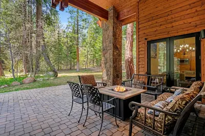 a patio with a table and chairs on a house at Spectacular low elevation home at its finest! in Incline Village