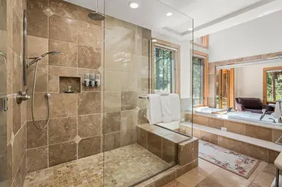 a bathroom with a shower with a glass door at Spectacular low elevation home at its finest! in Incline Village