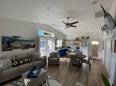 a living room with a couch and a table at California Cottage in Tracy