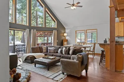 a living room with a couch and a table at Tranquil Tahoe A-Frame Walk to Beach in Tahoe Vista