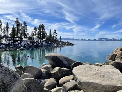 a large group of rocks on the shore of a lake at Tranquil Tahoe A-Frame Walk to Beach in Tahoe Vista