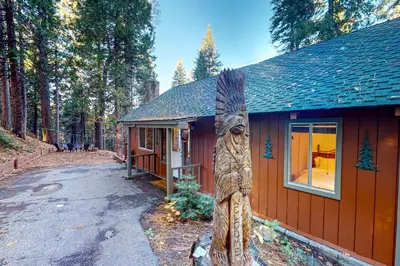 a house with a totem pole in front of it at Casa nel Bosco in Arnold