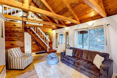 a living room with a couch and a staircase at Casa nel Bosco in Arnold