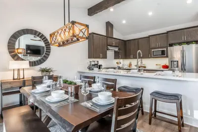 a kitchen and dining room with a table and chairs at Creekhouse 1380 in Mammoth Lakes