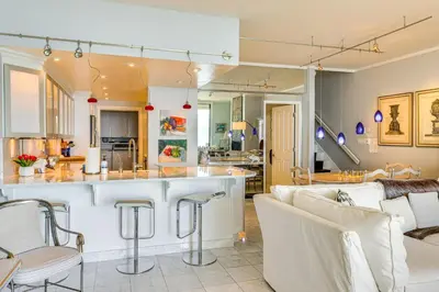 a kitchen and living room with a couch and a counter at Lake Tahoe Gem with Furnished Deck and Water Views! in Incline Village