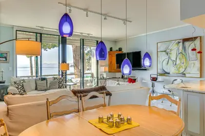 a kitchen and living room with a table and chairs at Lake Tahoe Gem with Furnished Deck and Water Views! in Incline Village