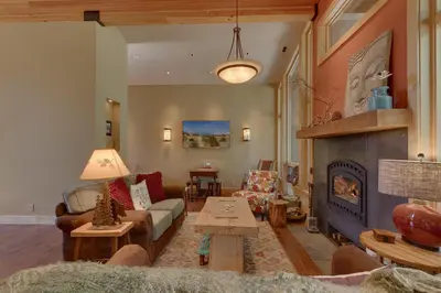 a living room with a couch and a fireplace at Fairway Favorite - Walk to Tahoe City Shops, Dining & Lake - Pet Friendly in Tahoe City