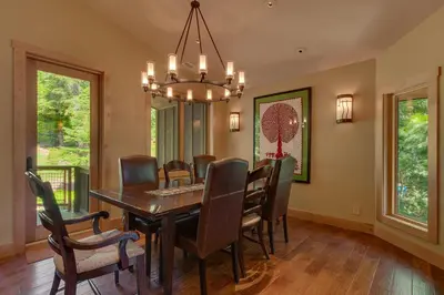 a dining room with a table and chairs and a chandelier at Fairway Favorite - Walk to Tahoe City Shops, Dining & Lake - Pet Friendly in Tahoe City