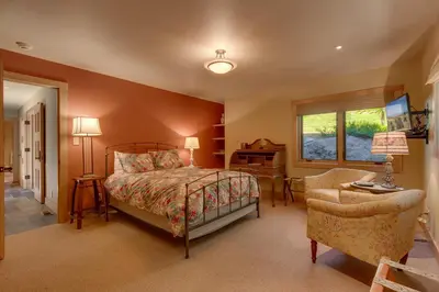 a bedroom with a bed and a desk and a chair at Fairway Favorite - Walk to Tahoe City Shops, Dining & Lake - Pet Friendly in Tahoe City