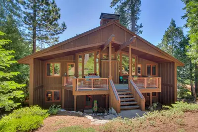 a large wooden house with a wrap around deck at Fairway Favorite - Walk to Tahoe City Shops, Dining & Lake - Pet Friendly in Tahoe City
