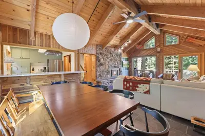 a dining room with a table and a couch at Sleeping Bear Lodge- Remodeled 3BR Cabin- Fireplace- Ski Shuttle- Pet-Friendly in Truckee