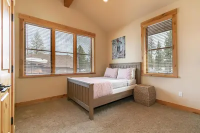 a bedroom with a bed in a room with windows at Trestlewood Lodge at Schaffers Mill - Gorgeous 3 BR w Golf Course Views - Extended Stays Welcome! in Truckee