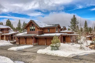 a large wooden house with snow on the ground at Trestlewood Lodge at Schaffers Mill - Gorgeous 3 BR w Golf Course Views - Extended Stays Welcome! in Truckee