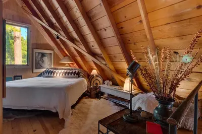 a bedroom with a bed and a wooden ceiling at Falcon's Rest - Ski and Summer Cabin in The Heart of North Lake Tahoe- Gas Fireplace in Carnelian Bay