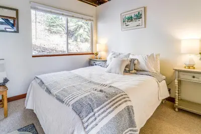 a bedroom with a bed and a window at Serene Lakes Cabin with Deck Dog Friendly! in Soda Springs