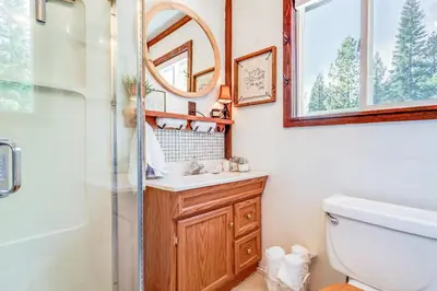 a bathroom with a sink and a mirror at Serene Lakes Cabin with Deck Dog Friendly! in Soda Springs