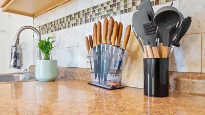 a kitchen counter with utensils in a container and a sink at Midtown Flight Deck: 2BR Gem in Reno