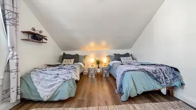 a attic bedroom with two beds at Midtown Flight Deck: 2BR Gem in Reno