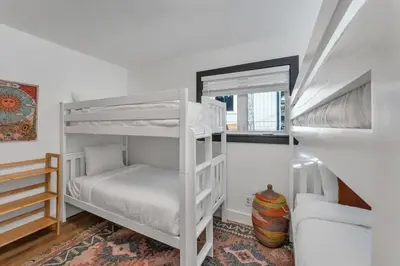a bedroom with two bunk beds and a window at Stylish 3BR Near Trails w Hot Tub in Tahoe City